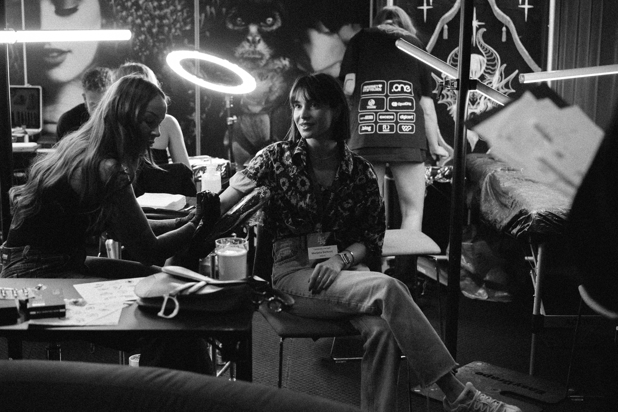 Marijana getting a tattoo at Nordic Domain Days 2026, in black and white